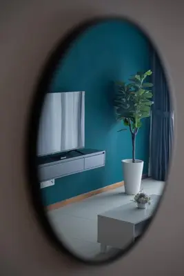 a mirror reflecting a room with a potted plant at Family Seaview Suite with 3 Rooms by The Only Bnb in Tanjong Tokong