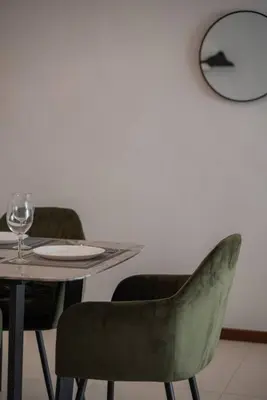 a table and chairs with a plate and wine glass at Family Seaview Suite with 3 Rooms by The Only Bnb in Tanjong Tokong