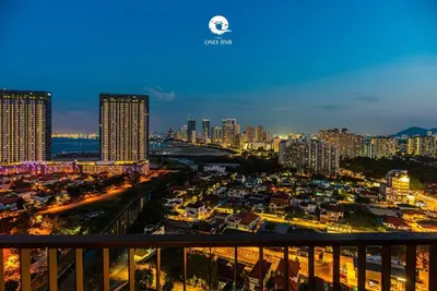 a city skyline at night with tall buildings at Family Seaview Suite with 3 Rooms by The Only Bnb in Tanjong Tokong