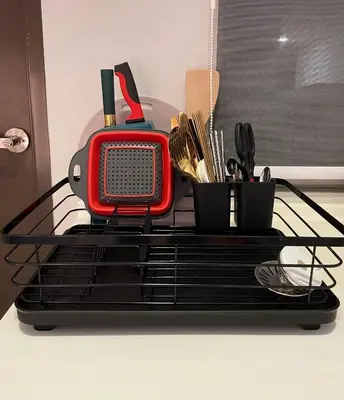 a red appliance sitting on a black shelf with utensils at JS Ipoh Homestay @ The Majestic Ipoh in Ipoh