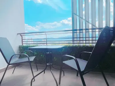 a table and chairs on a balcony with a view at JS Ipoh Homestay @ The Majestic Ipoh in Ipoh