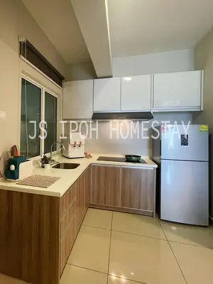 a kitchen with a refrigerator and a sink at JS Ipoh Homestay @ The Majestic Ipoh in Ipoh
