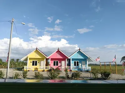 a row of colorful houses on the beach at Laman D'Arni in Sungai Besar