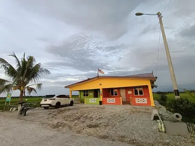 a small house with a car parked in front of it at Laman D'Arni in Sungai Besar