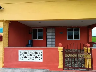 a red and yellow house with a red and yellow wall at Laman D'Arni in Sungai Besar