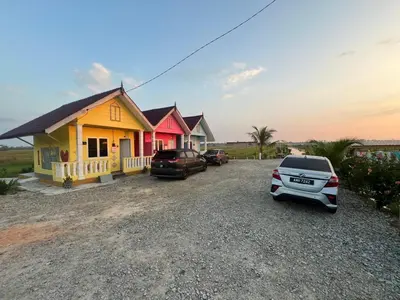 a house with cars parked in front of it at Laman D'Arni in Sungai Besar