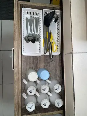 a drawer full of kitchen utensils in a cabinet at Biella Homestay Apartment for Muslim in Tanah Rata