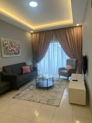 a living room with a couch and a table at Biella Homestay Apartment for Muslim in Tanah Rata