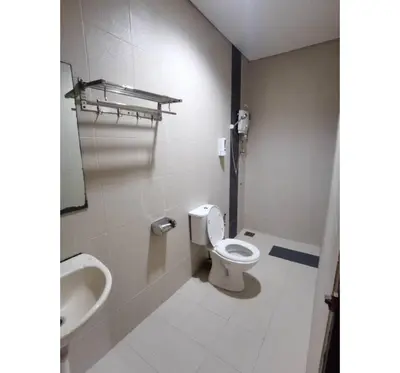 a bathroom with a toilet and a sink at Hotel O Pavilion Inn Hotel in Lumut