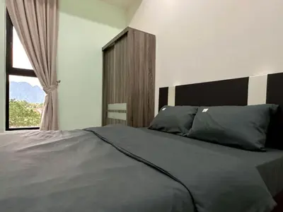 a bedroom with a large bed with a window at Ipoh Simple Homestay by Comfort Home in Ipoh