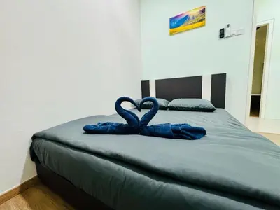 two towels in the shape of hearts are on a bed at Ipoh Simple Homestay by Comfort Home in Ipoh