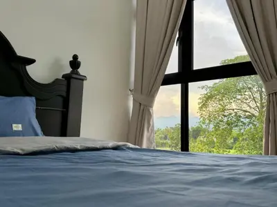 a bedroom with a bed and a large window at Ipoh Simple Homestay by Comfort Home in Ipoh
