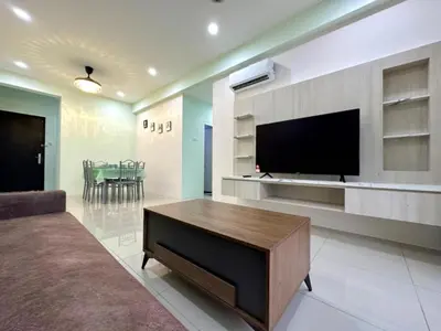 a living room with a flat screen tv and a table at Ipoh Simple Homestay by Comfort Home in Ipoh