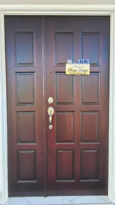 a large wooden door with a sign on it at Paddy Villea Inn SPT Penang in Permatang Pauh