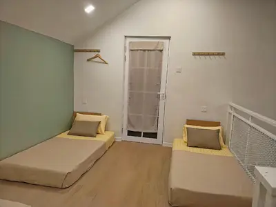 a small room with two beds and a window at Paddy Villea Inn SPT Penang in Permatang Pauh
