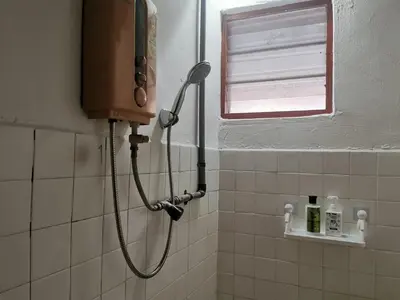 a shower in a tiled bathroom with a window at Homestay Taman Mas, Kg Koh in Sitiawan