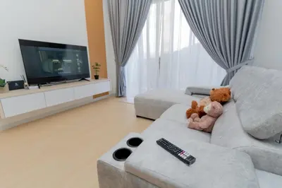 a living room with a couch with two teddy bears at Muna The Cove Ipoh Garden East 3R2B 8pax in Ipoh