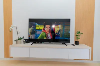 a flat screen tv sitting on top of a white entertainment center at Muna The Cove Ipoh Garden East 3R2B 8pax in Ipoh