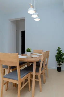 a dining room with a wooden table and chairs at Muna The Cove Ipoh Garden East 3R2B 8pax in Ipoh