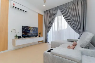 a living room with a couch and a tv at Muna The Cove Ipoh Garden East 3R2B 8pax in Ipoh