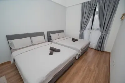 a bedroom with two beds and a window at Muna The Cove Ipoh Garden East 3R2B 8pax in Ipoh