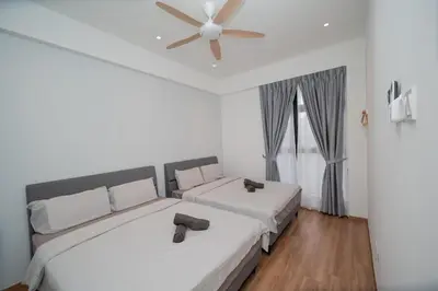 a bedroom with two beds and a ceiling fan at Muna The Cove Ipoh Garden East 3R2B 8pax in Ipoh