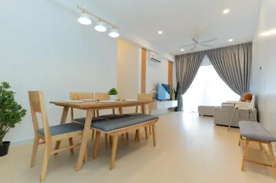 a living room with a wooden table and chairs at Muna The Cove Ipoh Garden East 3R2B 8pax in Ipoh