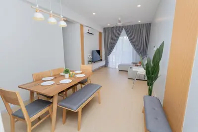 a living room with a wooden table and chairs at Muna The Cove Ipoh Garden East 3R2B 8pax in Ipoh