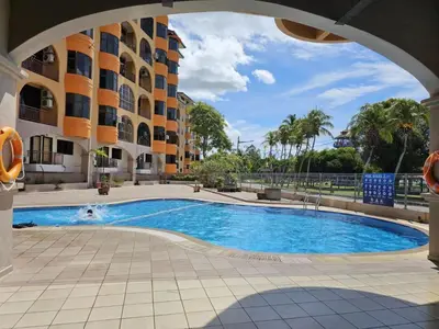 a swimming pool in the middle of a building at Fukuda Minshuku Japanese style in Lumut