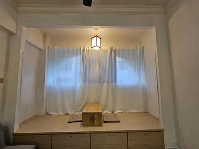 a room with a window with a table and a light at Fukuda Minshuku Japanese style in Lumut