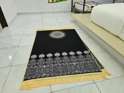 a black and white rug on the floor in a bedroom at Fukuda Minshuku Japanese style in Lumut