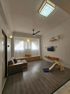 a living room with a couch and a window at Fukuda Minshuku Japanese style in Lumut