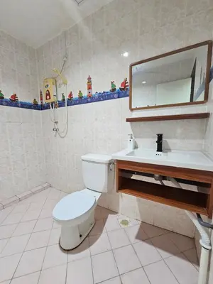 a bathroom with a toilet and a sink and a mirror at Fukuda Minshuku Japanese style in Lumut