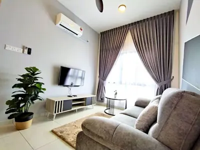 a living room with a couch and a tv at The Horizon Ipoh Stay by Grab A Stay in Ipoh