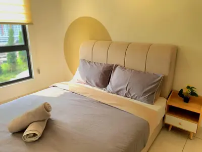 a bedroom with a large white bed with a hat on it at Mocha Suite @ The Horizon Ipoh [4 to 6 pax] in Ipoh