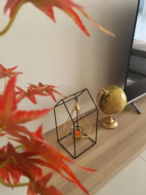 a table with a lamp and a brass globe on it at Mocha Suite @ The Horizon Ipoh [4 to 6 pax] in Ipoh
