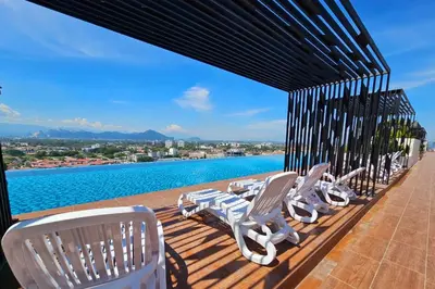 a row of chairs sitting on a deck overlooking the water at Mocha Suite @ The Horizon Ipoh [4 to 6 pax] in Ipoh