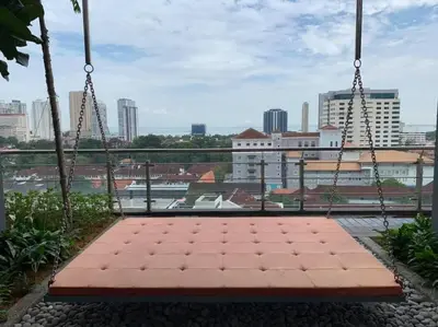 a swing with a view of a city at Momento Stay Georgetown 10pax \u4e54\u6cbb\u5e02\u4e2d\u5fc3-\u6d77\u666f\u623fSeaview Room in George Town