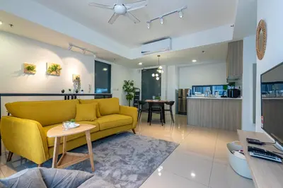 a living room with a yellow couch and a table at Momento Stay Georgetown 10pax \u4e54\u6cbb\u5e02\u4e2d\u5fc3-\u6d77\u666f\u623fSeaview Room in George Town