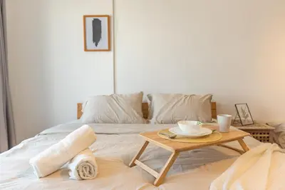 a bed with a table with two cups on it at Momento Stay Georgetown 10pax \u4e54\u6cbb\u5e02\u4e2d\u5fc3-\u6d77\u666f\u623fSeaview Room in George Town