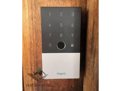 a close up of a remote control on a wooden door at Ventura Hotel and Tours in Gua Musang