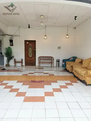 a living room with a couch and a table at Ventura Hotel and Tours in Gua Musang