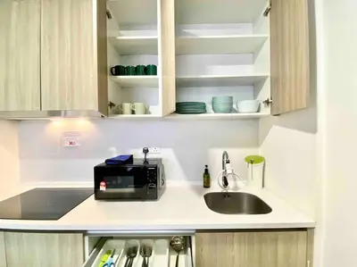 a kitchen counter with a sink and a microwave at Tropicana 218 Macalister #Top Floor #WideAngleViews #InfinityPool #Georgetown #8pax #3BR 2bath #2Queen 4Single #Near island hospital #Quality well maintained #Private host in George Town