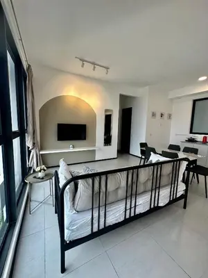 a living room with a couch and a tv at Urban Suites Georgetown by BNB4U in Jelutong
