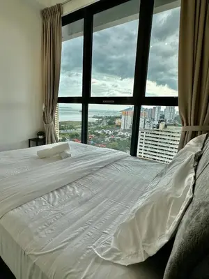 a white bed in a room with a large window at Urban Suites Georgetown by BNB4U in Jelutong