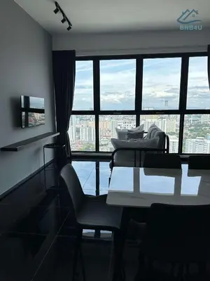 a living room with a table and chairs and a large window at Urban Suites Georgetown by BNB4U in Jelutong