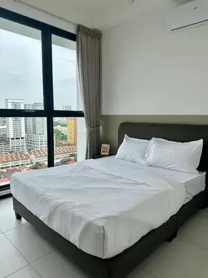 a bedroom with a large bed with a large window at Urban Suites Georgetown by BNB4U in Jelutong
