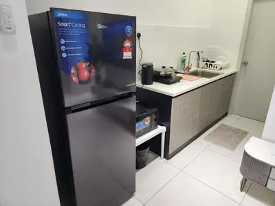 a stainless steel refrigerator in a kitchen with a stove at The Horizon - Ipoh in Ipoh