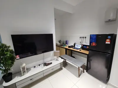 a room with a desk and a large screen tv at Ipoh City Executive Suite - The Horizon in Ipoh