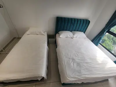 two beds in a small room with a window at Ipoh City Executive Suite - The Horizon in Ipoh